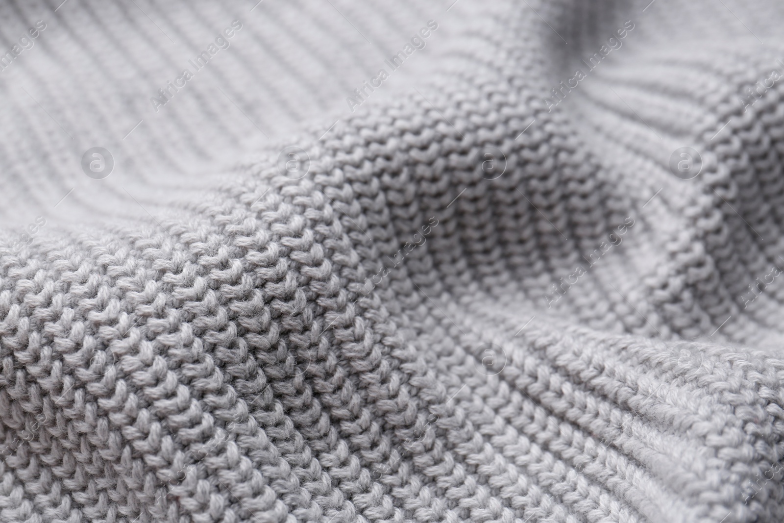 Photo of Grey knitted fabric as background, closeup view