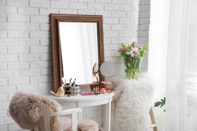 Photo of Beautiful mirror on table in modern makeup room