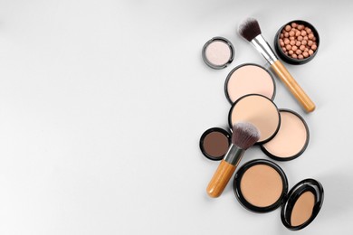 Photo of Flat lay composition with makeup brushes on light background, space for text