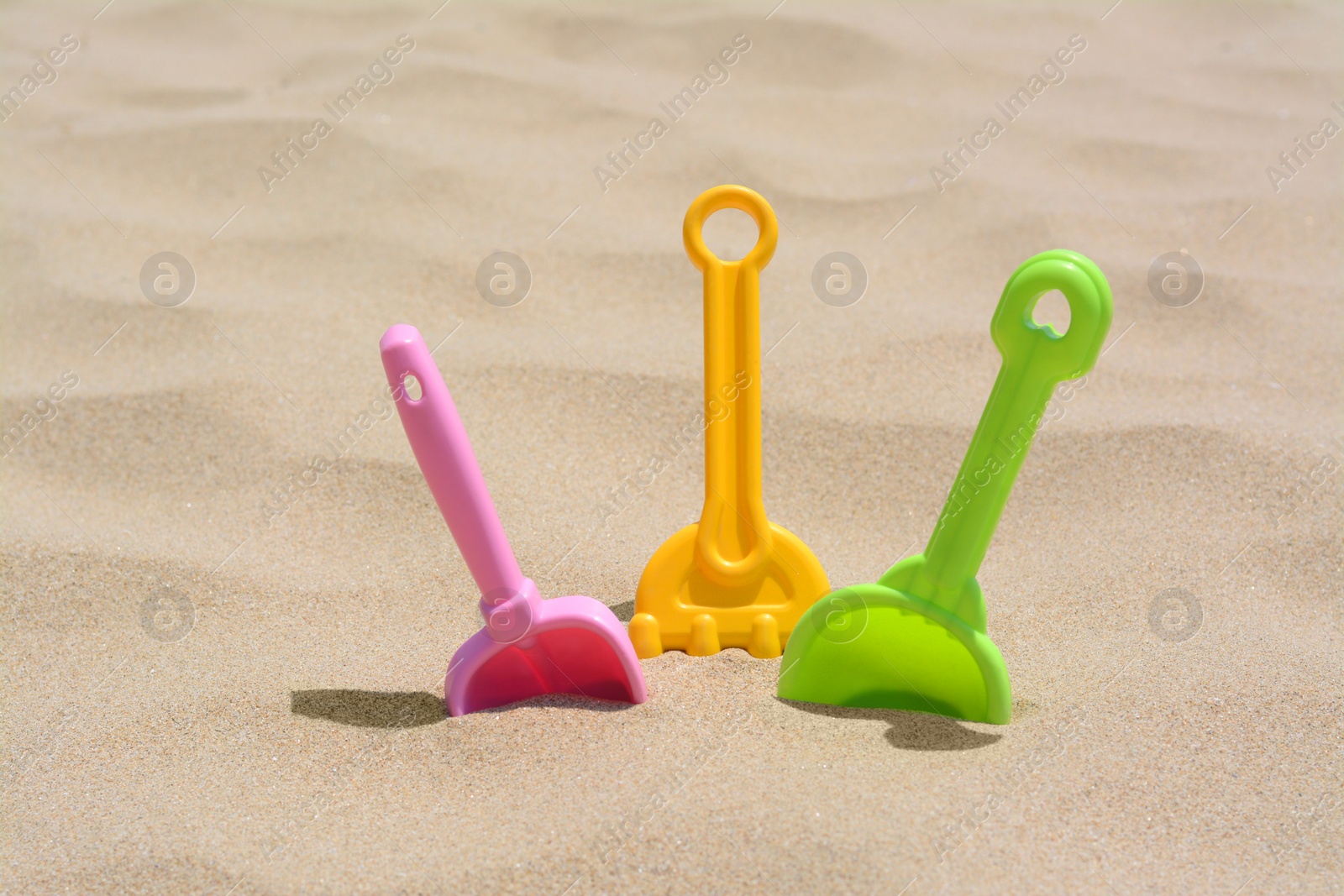 Photo of Set of colorful beach toys on sand