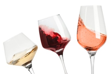 Image of Different types of wine splashing in glasses on white background