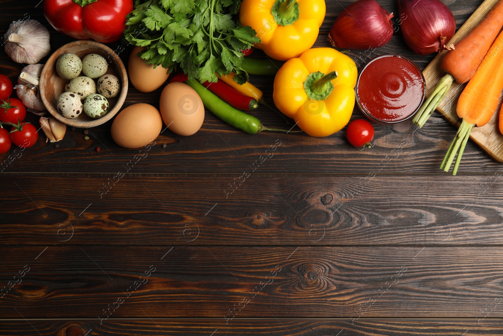 Photo of Flat lay composition with ingredients for cooking on wooden table. Space for text