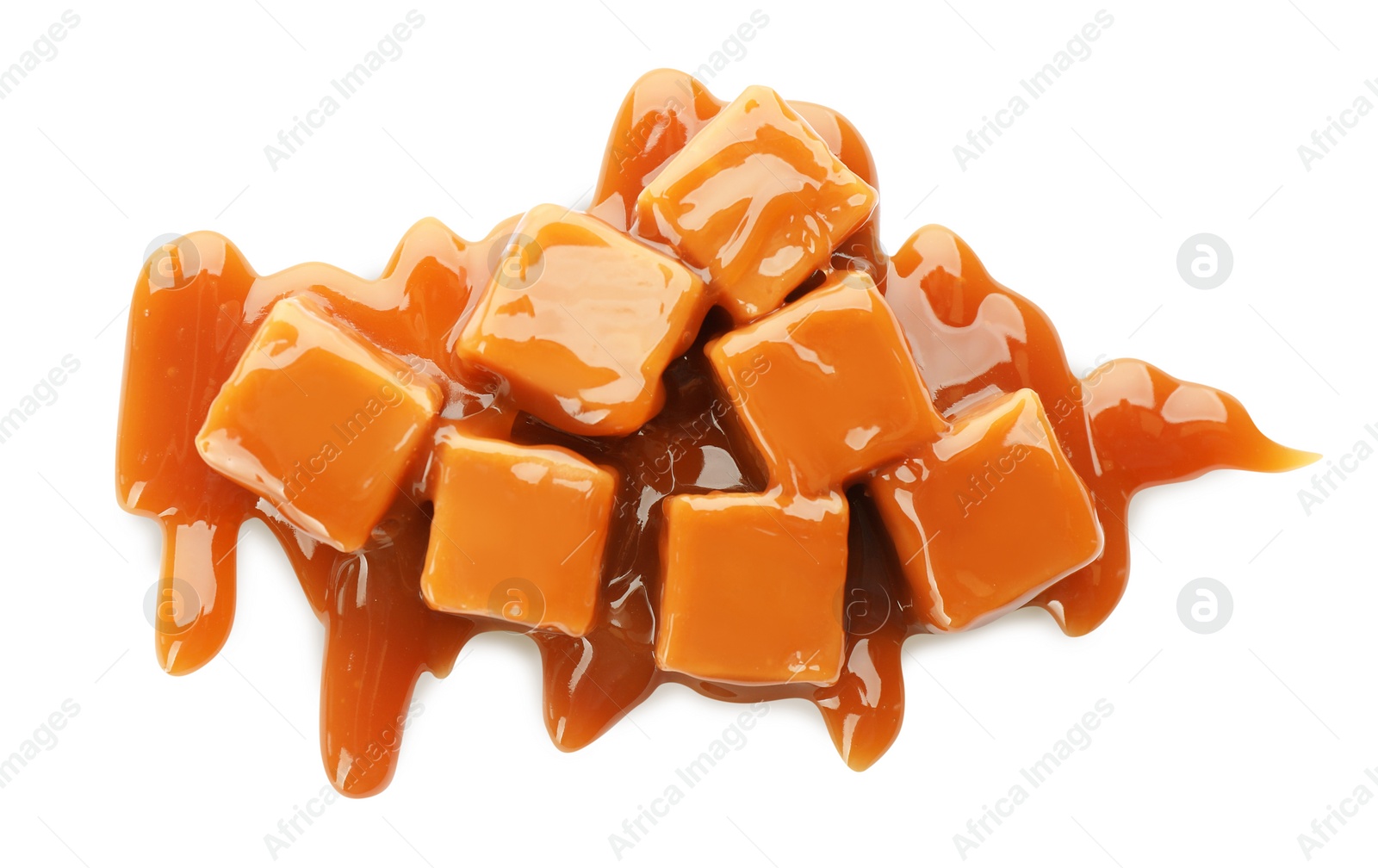 Photo of Heap of sweet caramel candies with topping isolated on white, top view