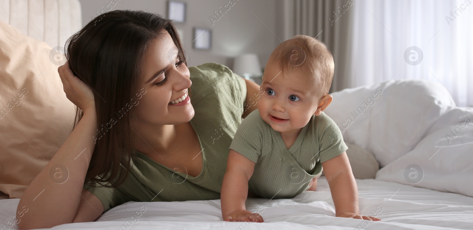 Image of Happy young mother with her cute baby at home. Banner design 