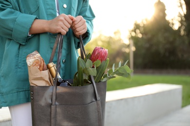 Woman with leather shopper bag outdoors, closeup