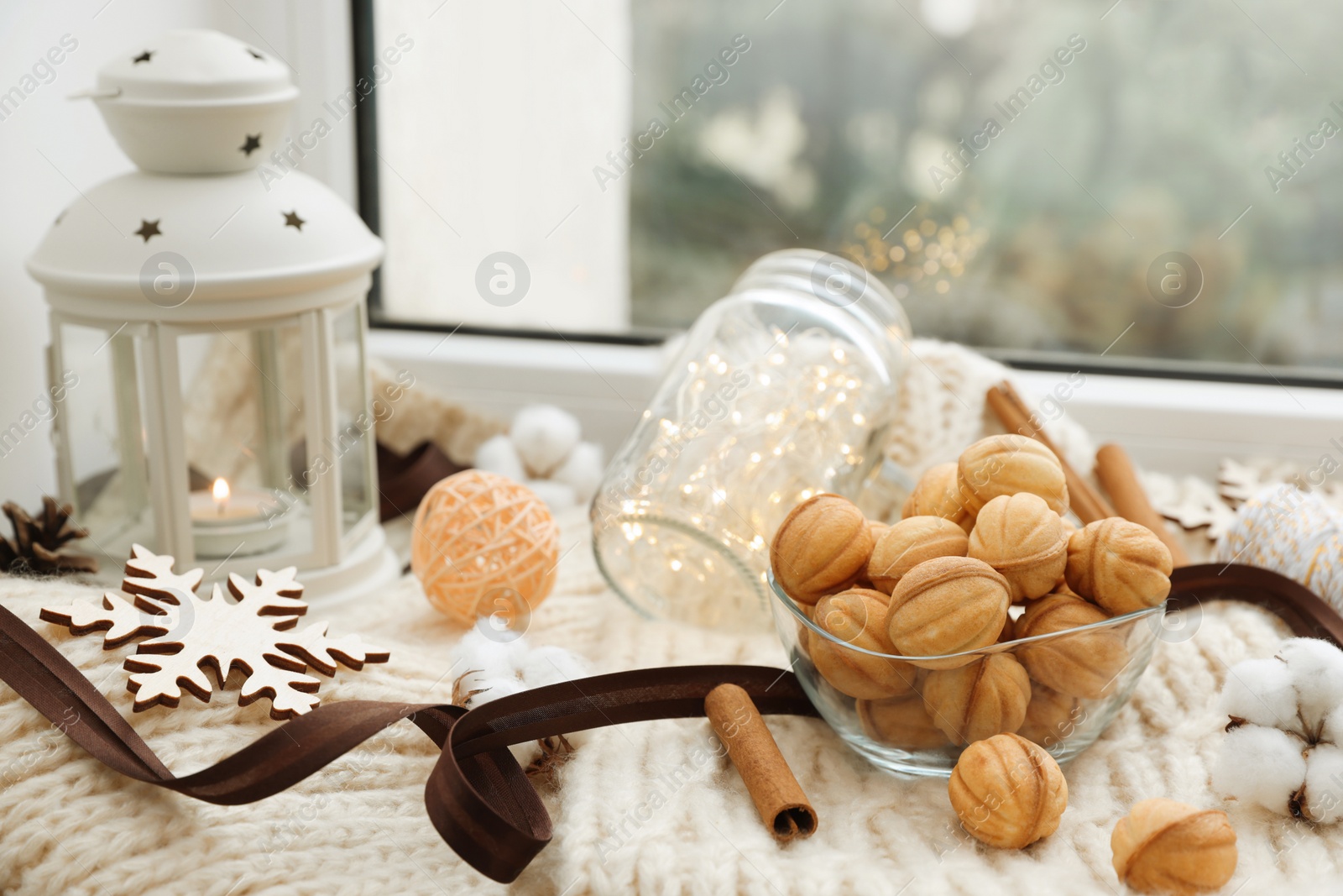 Photo of Delicious nut shaped cookies with boiled condensed milk and Christmas decor on window sill