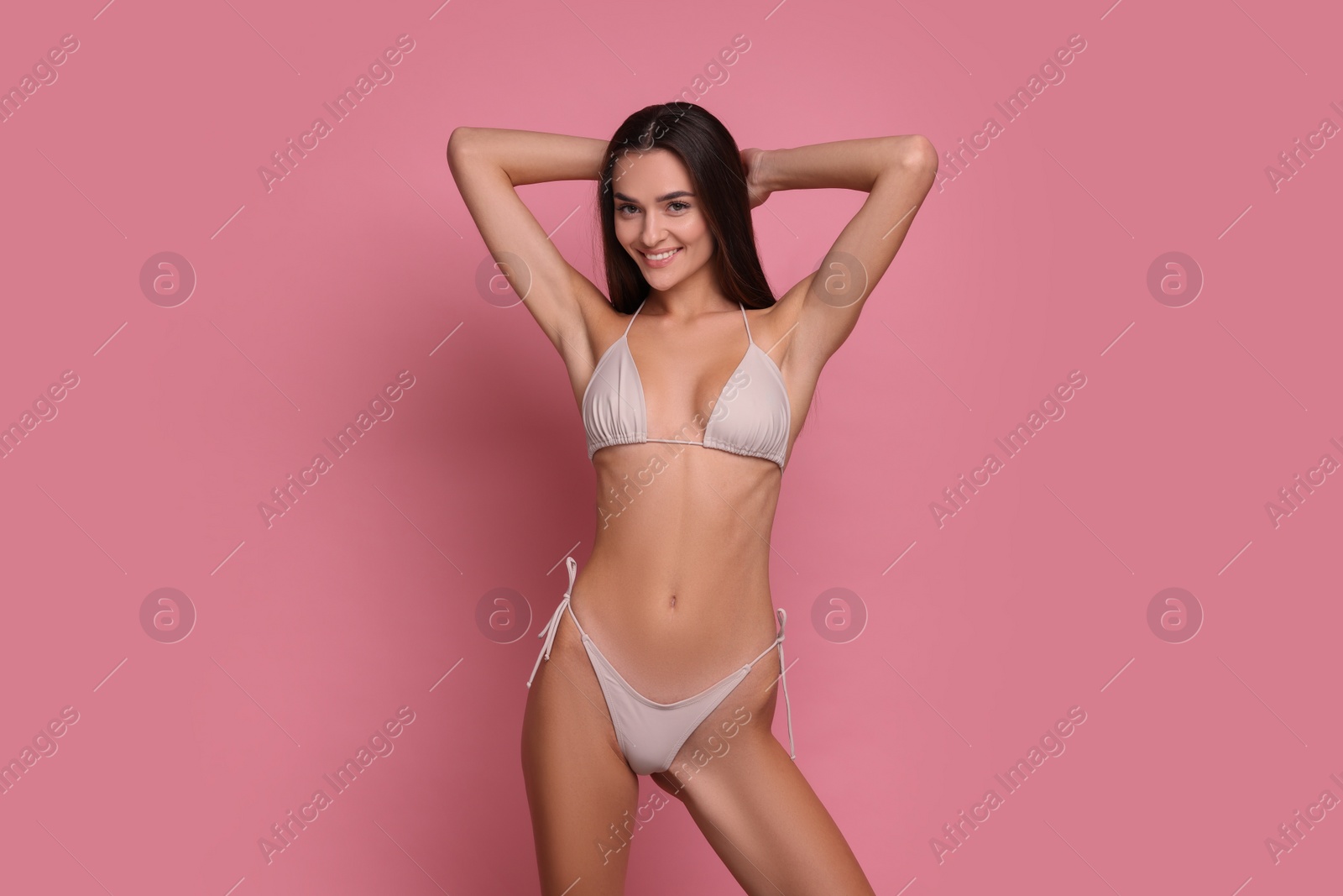 Photo of Young woman in stylish bikini on pink background