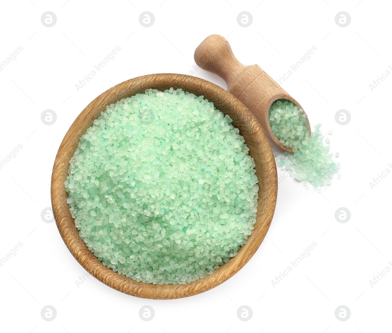 Photo of Bowl and scoop with turquoise sea salt isolated on white, top view