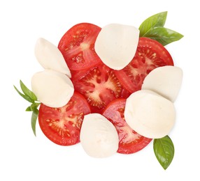 Photo of Delicious Caprese salad with tomatoes, mozzarella cheese and basil leaves isolated on white, top view