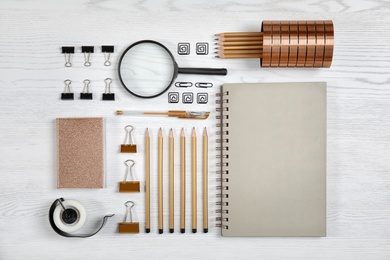 Different school stationery on wooden background, flat lay