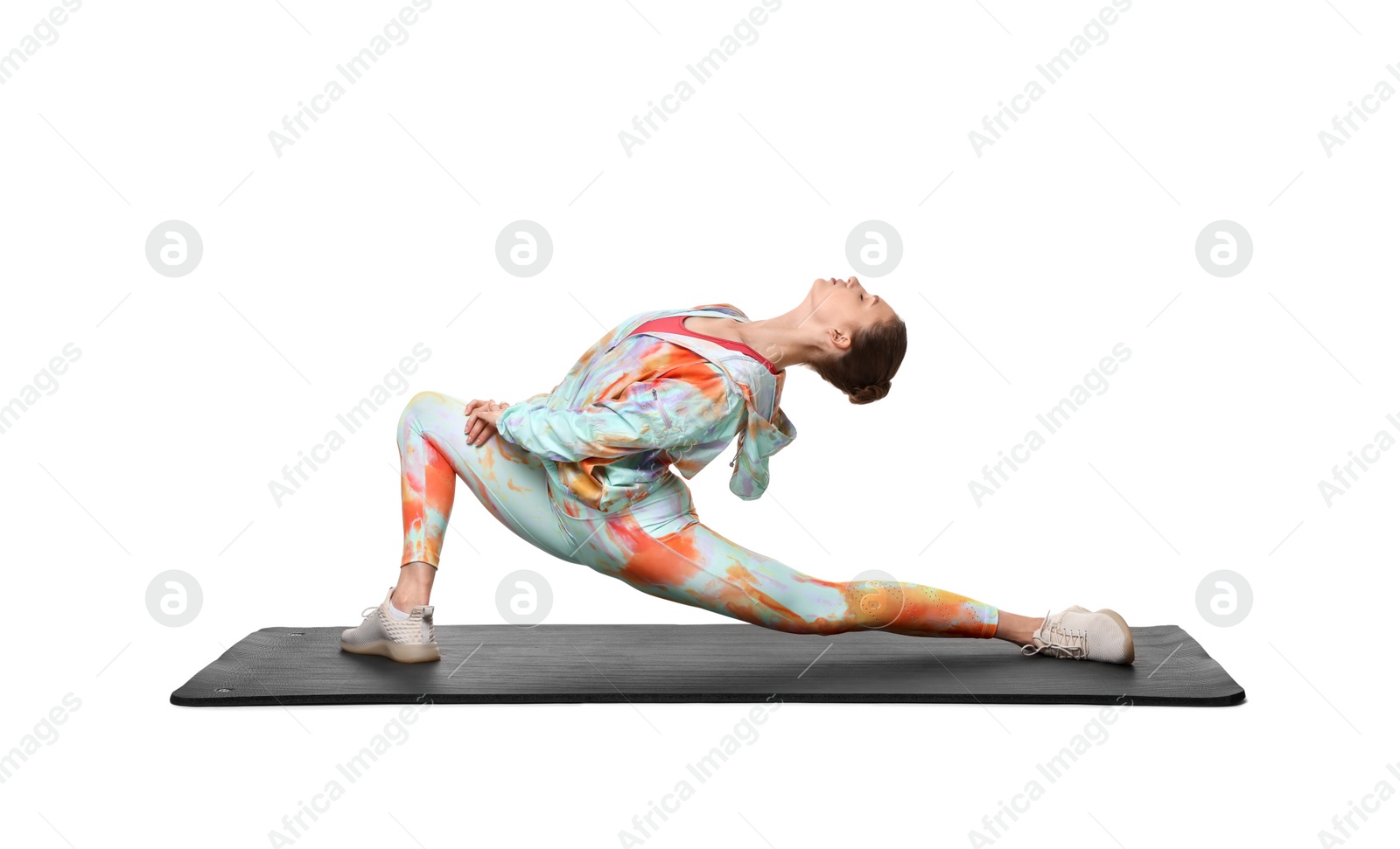 Photo of Yoga workout. Young woman stretching on white background