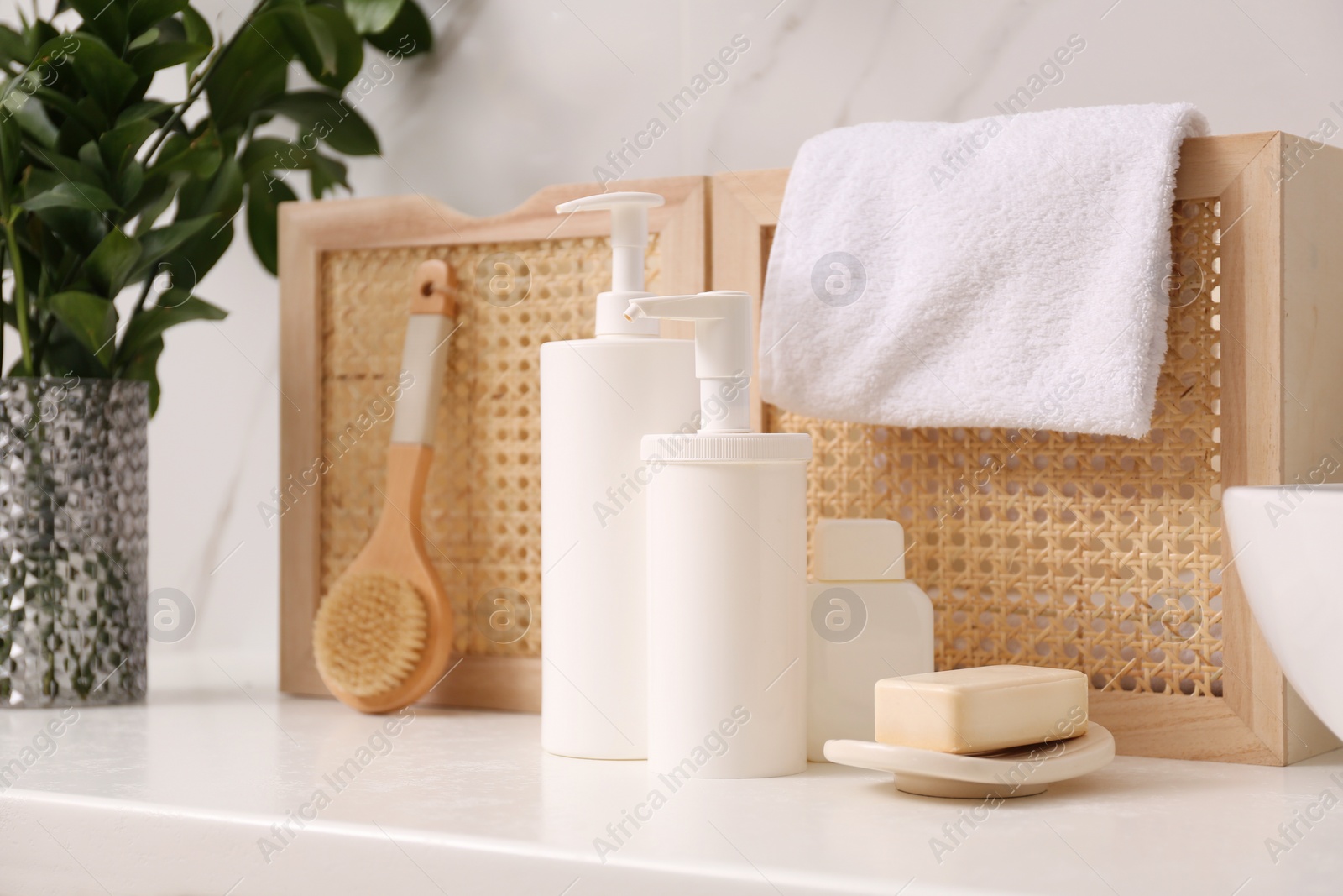 Photo of Toiletries and personal hygiene products on white countertop in bathroom