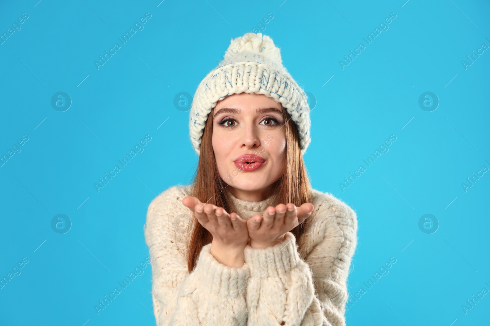 Photo of Young woman wearing Christmas sweater on blue background