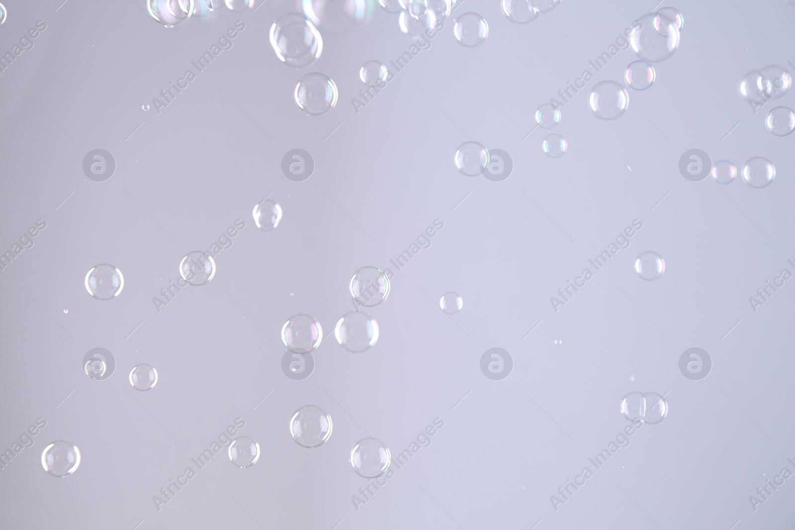 Photo of Beautiful transparent soap bubbles on grey background