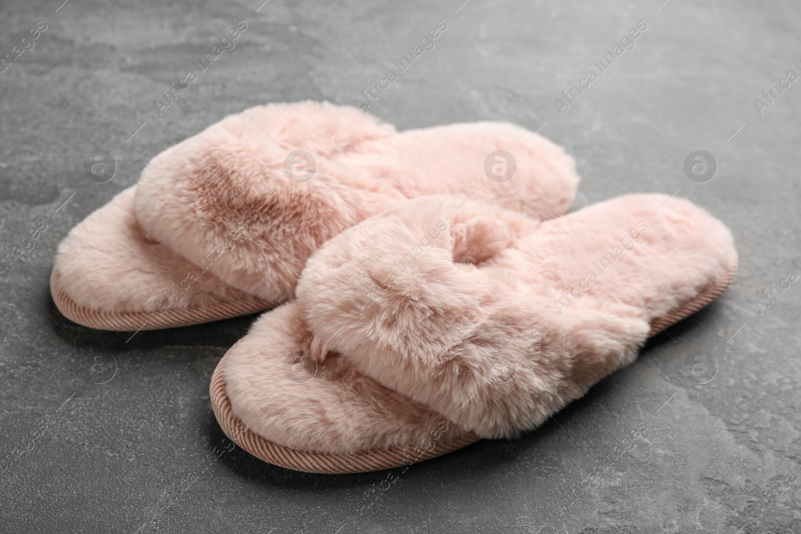 Photo of Pair of stylish soft slippers on grey background