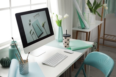 Photo of Stylish workplace interior with modern computer on desk