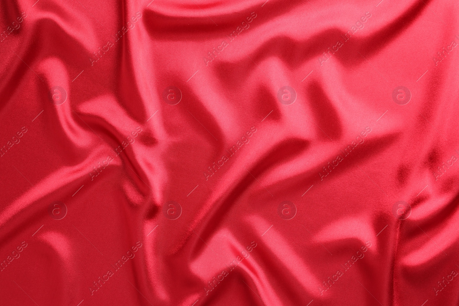 Photo of Texture of beautiful red silk fabric as background, closeup