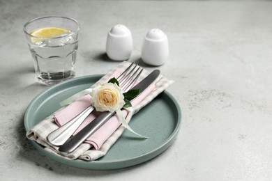 Beautiful table setting with fabric napkin and rose, space for text