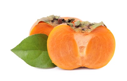 Photo of Halves of delicious ripe juicy persimmons and green leaf on white background