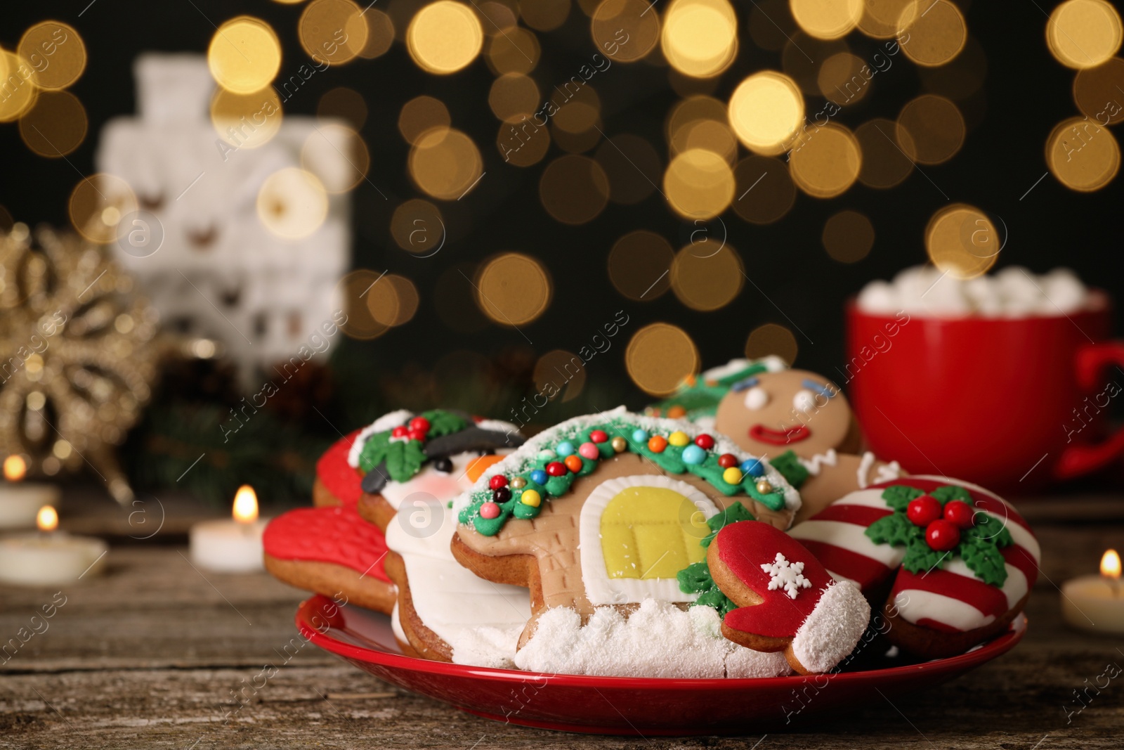 Photo of Sweet Christmas cookies on wooden table against blurred festive lights. Space for text