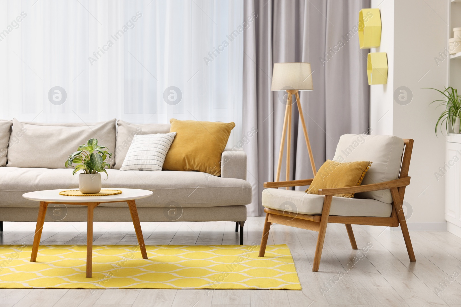 Photo of Spring atmosphere. Comfy sofa, coffee table and armchair in room