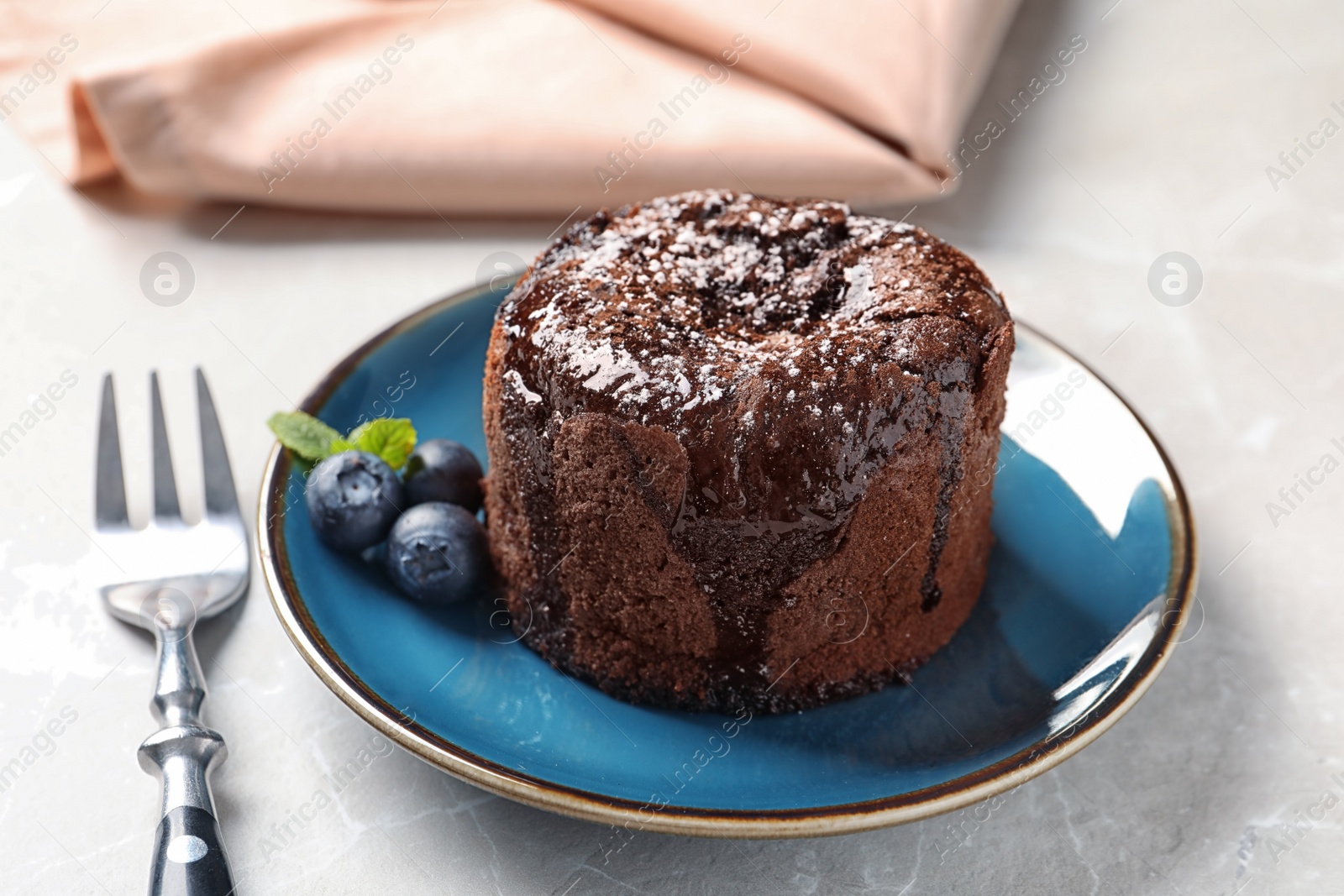 Photo of Plate of delicious fresh fondant with hot chocolate and blueberries on table. Lava cake recipe