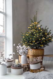 Blurred view of little Christmas tree in bedroom. Festive interior