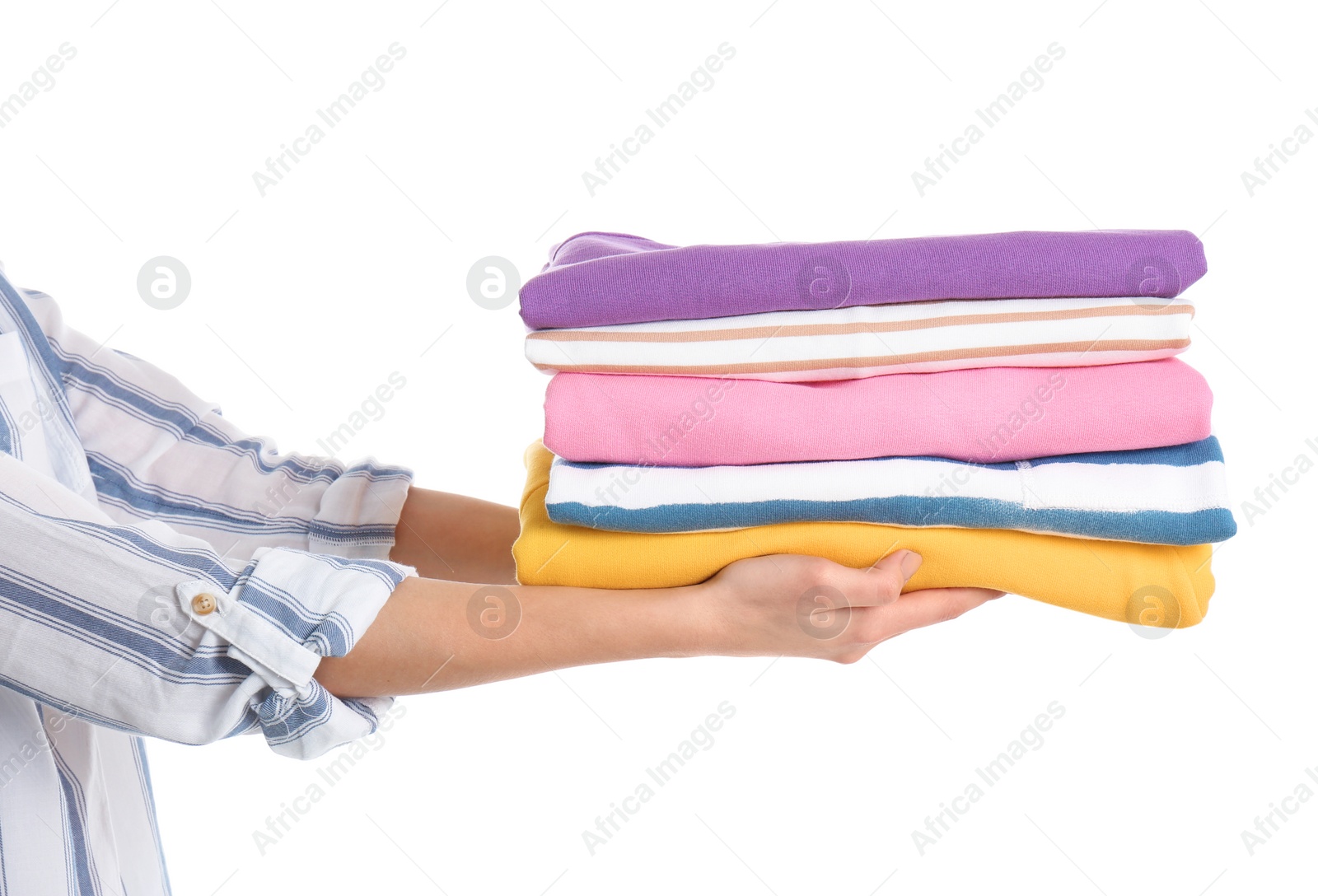 Photo of Young woman holding clean towels on white background, closeup. Laundry day