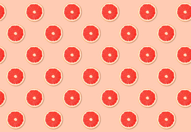 Image of Pattern of grapefruit slices on pale pink background
