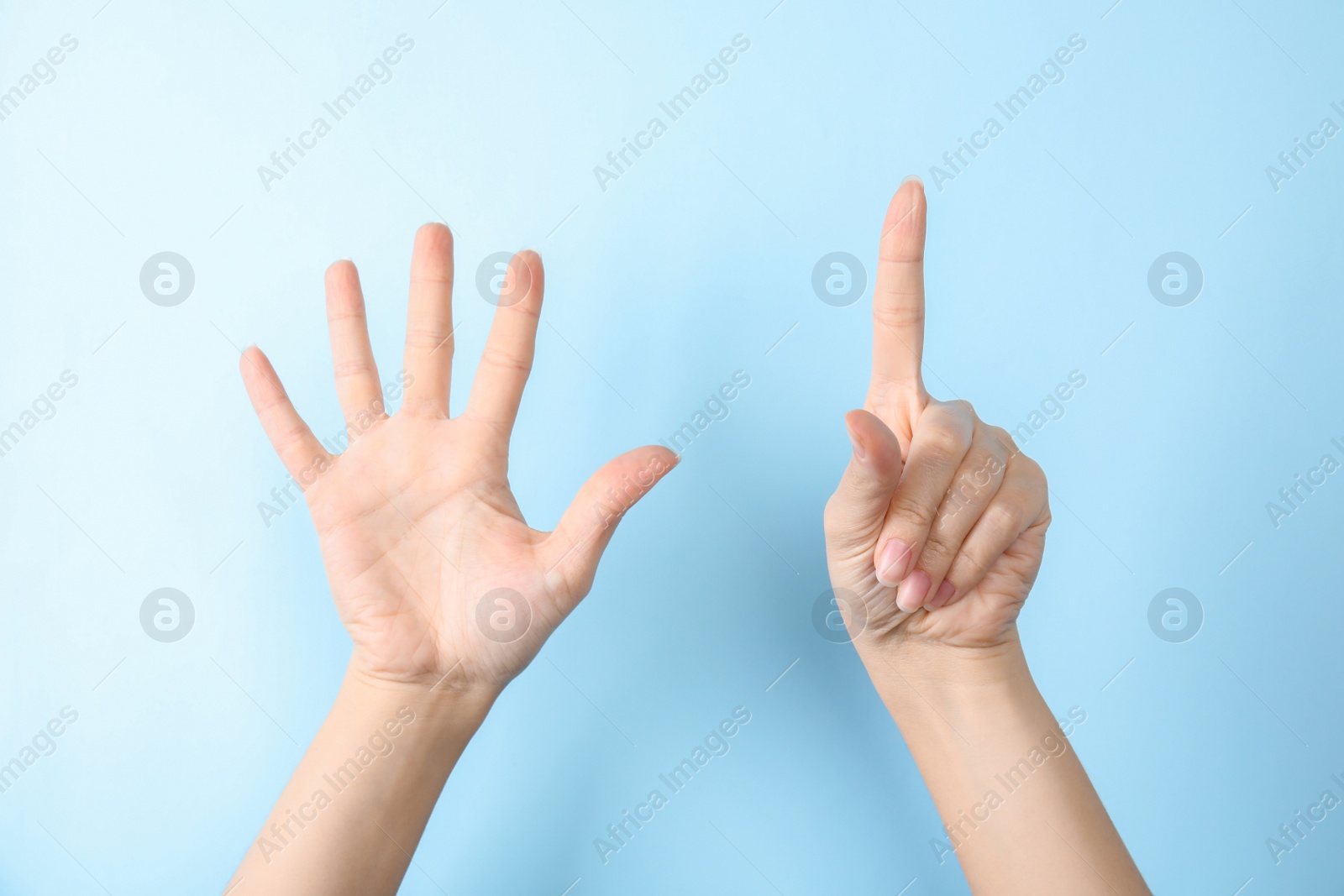 Photo of Woman showing sign six on color background, closeup. Body language