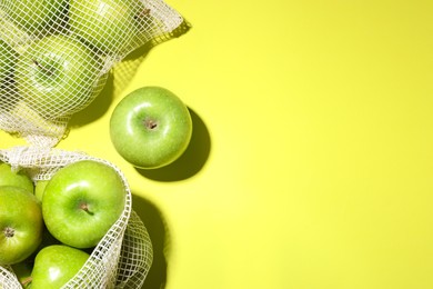 Photo of Ripe apples on light green background, flat lay. Space for text