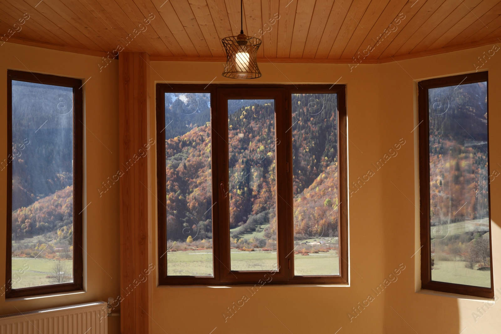 Photo of Empty room with clean windows and beige wall indoors