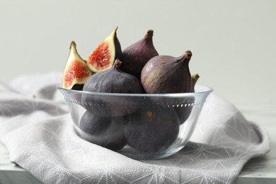 Photo of Whole and cut tasty fresh figs on table