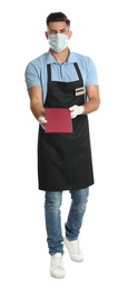 Photo of Waiter in medical face mask with menu on white background