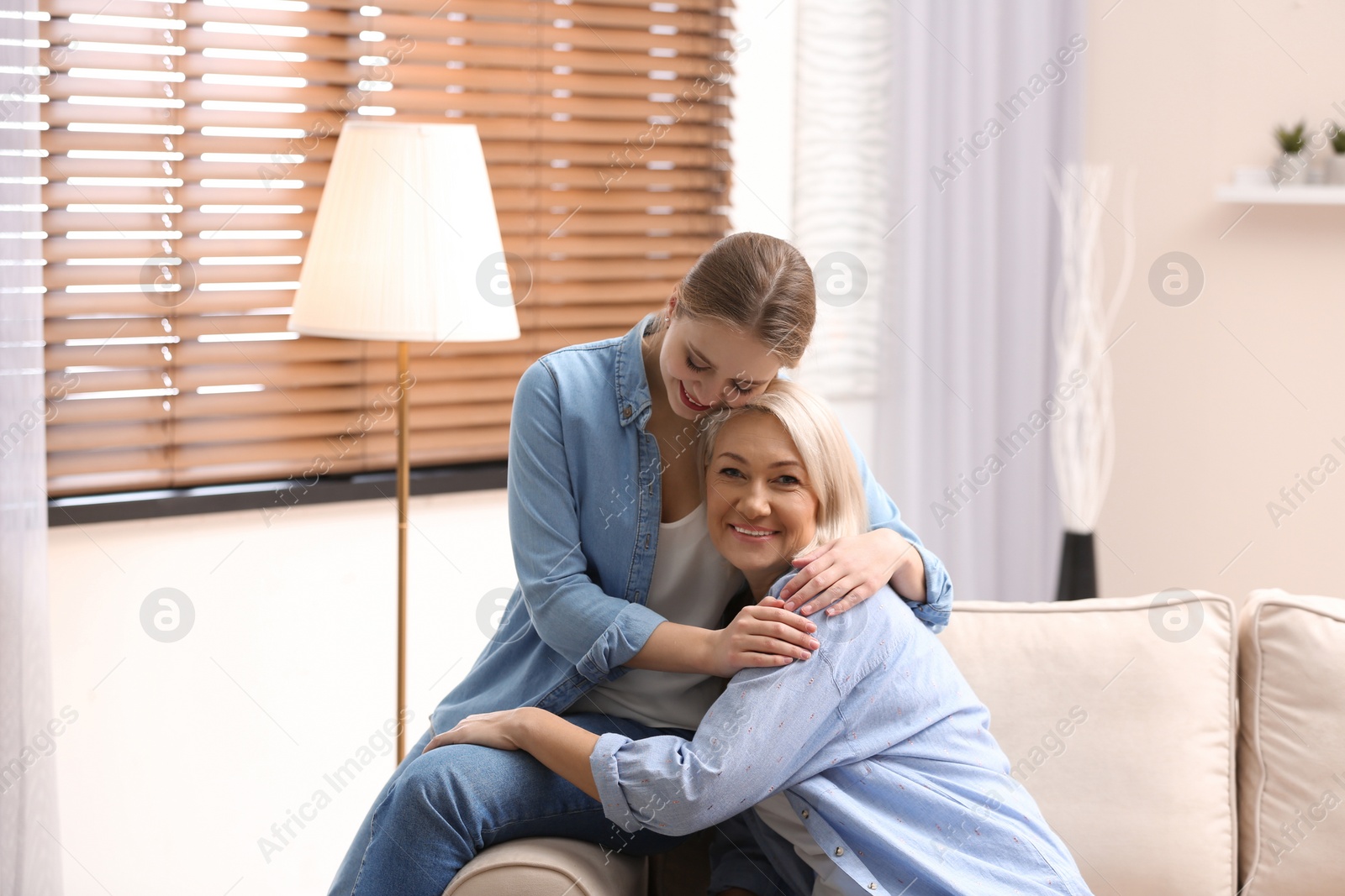 Photo of Mother and her adult daughter spending time together at home