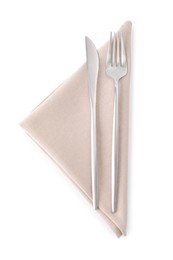 Photo of Beige napkin with silver fork and knife isolated on white, top view. Cutlery set