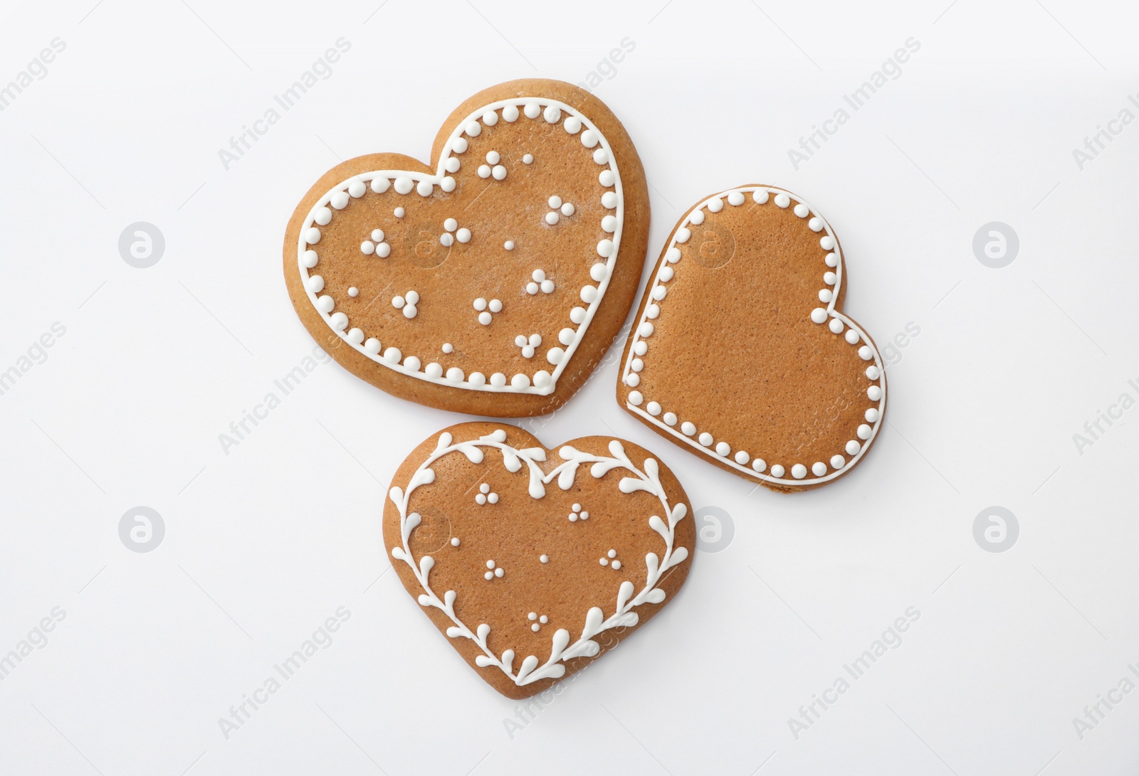 Photo of Christmas heart shaped gingerbread cookies on white background, top view