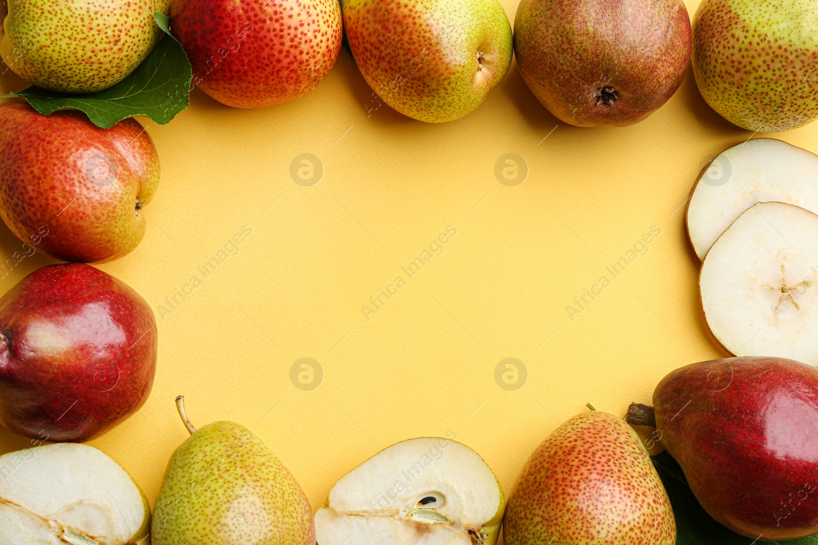 Photo of Ripe juicy pears on yellow background, flat lay. Space for text