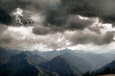 Image of Dark cloudy sky with lightnings and rain over beautiful mountains forest. Thunderstorm