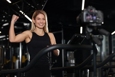 Photo of Fitness trainer recording online classes in gym