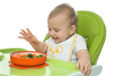 Photo of Cute little baby wearing bib while eating on white background