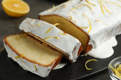 Photo of Tasty lemon cake with glaze on table, closeup