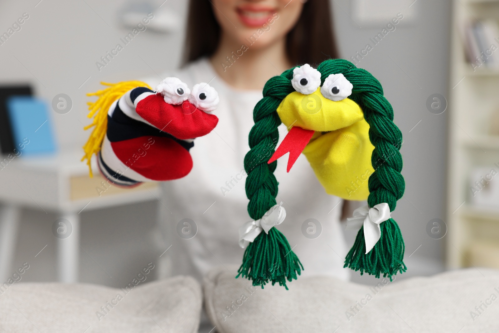 Photo of Woman performing puppet show at home, selective focus