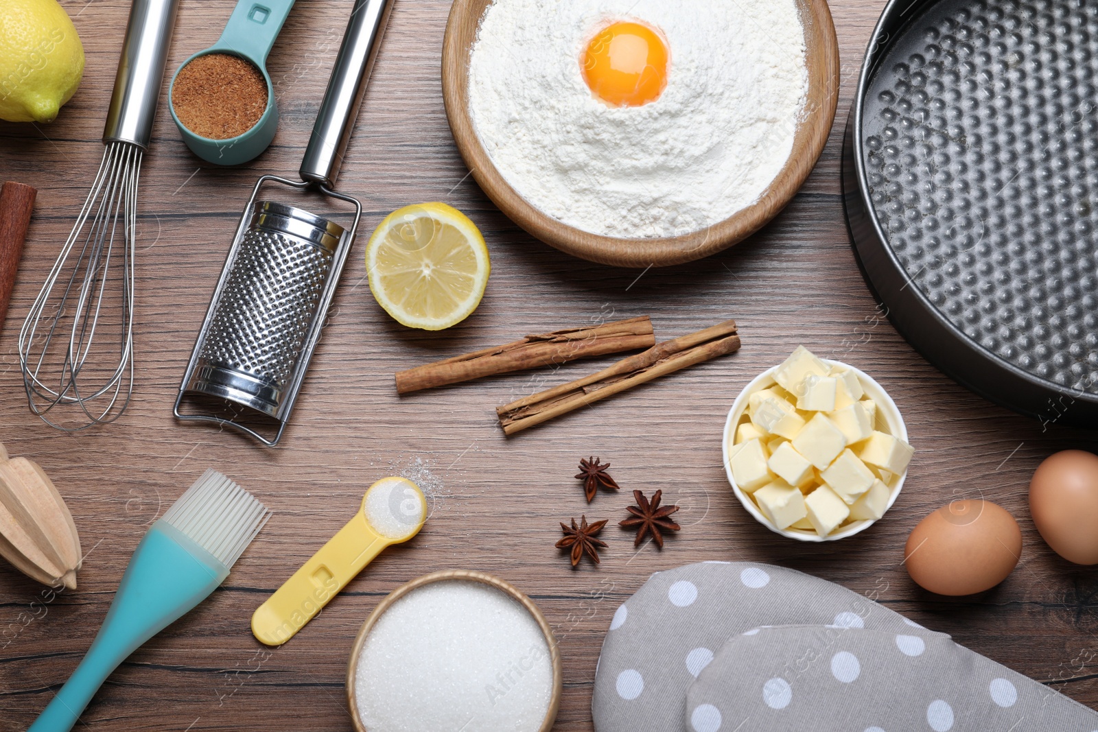 Photo of Cooking utensils and ingredients on wooden table, flat lay