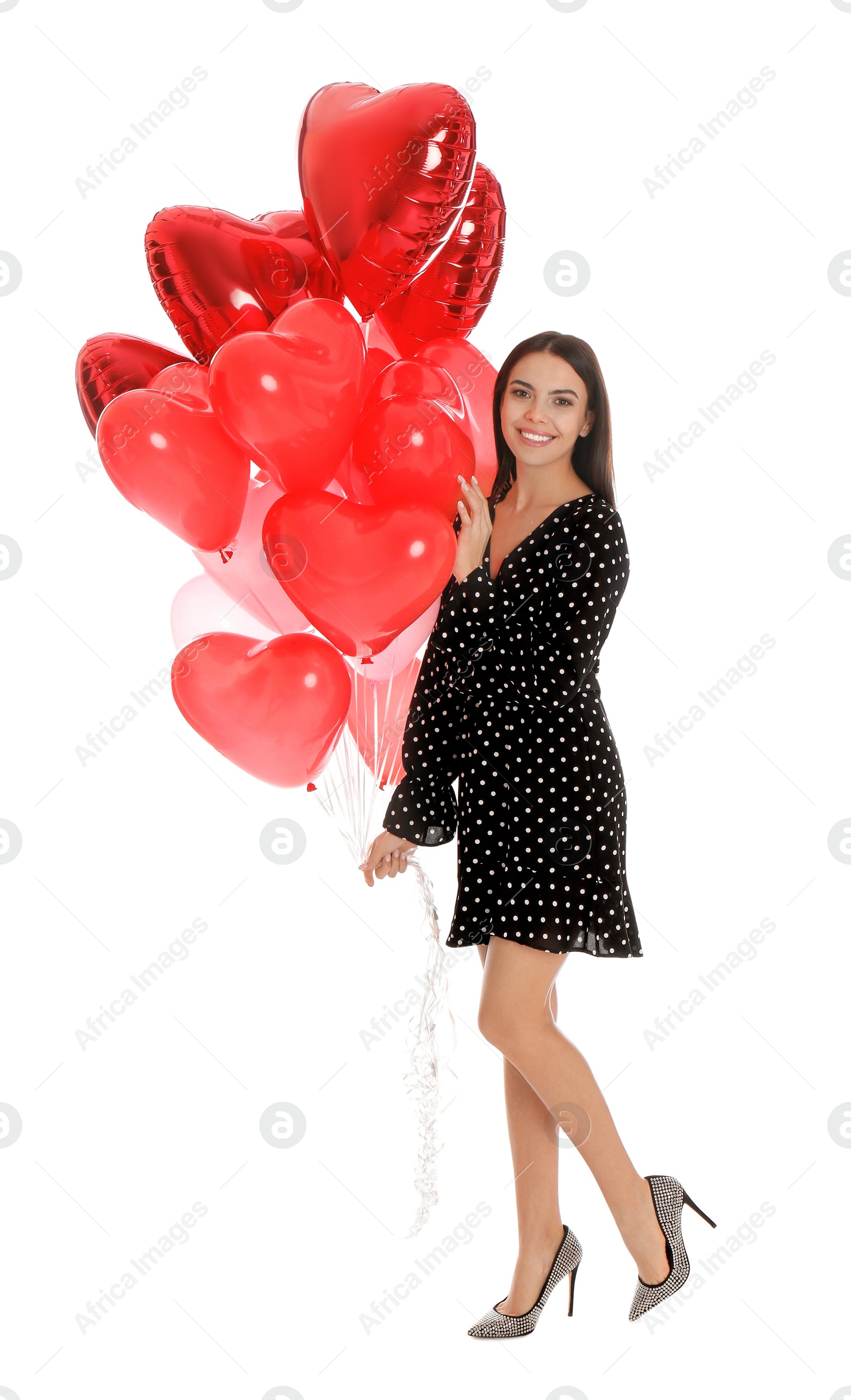 Photo of Beautiful young woman with heart shaped balloons isolated on white. Valentine's day celebration