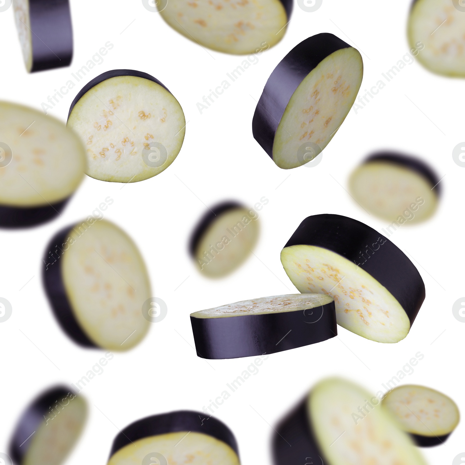 Image of Slices of eggplants falling on white background