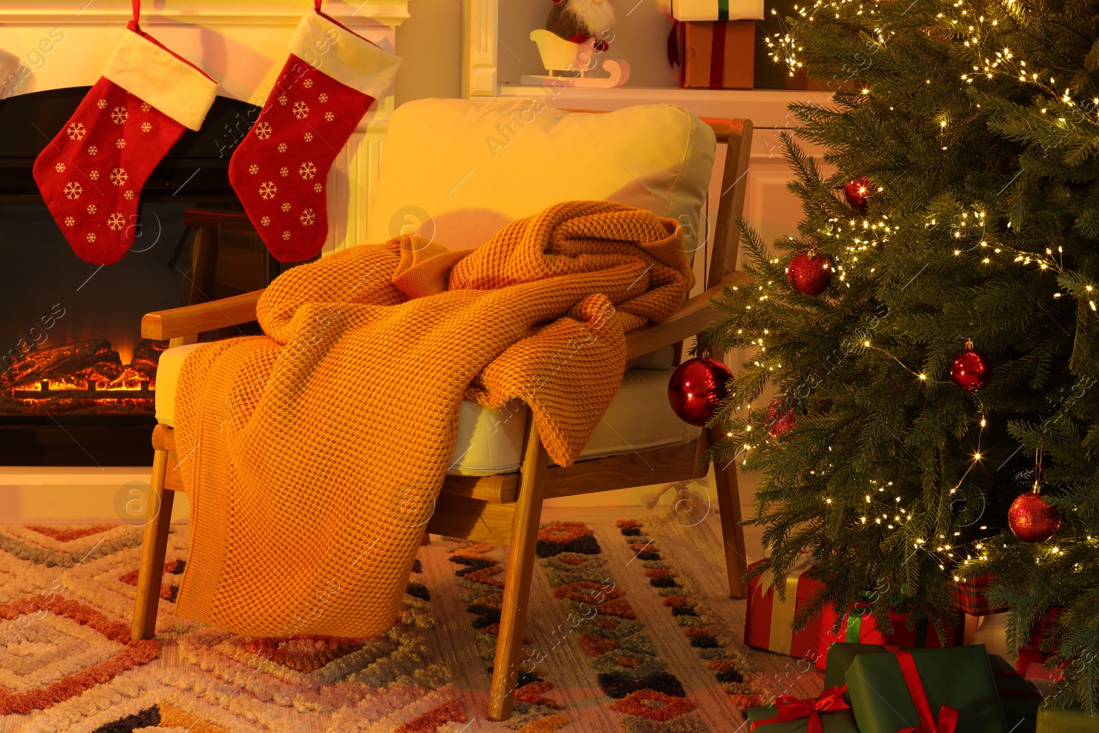 Photo of Living room interior with fireplace, armchair and Christmas decor