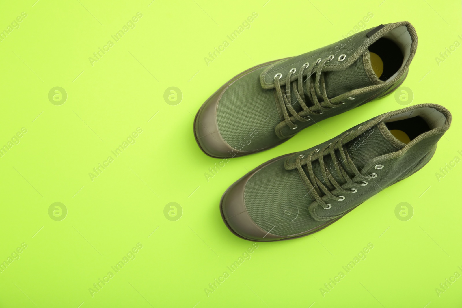 Photo of Pair of shoes on color background