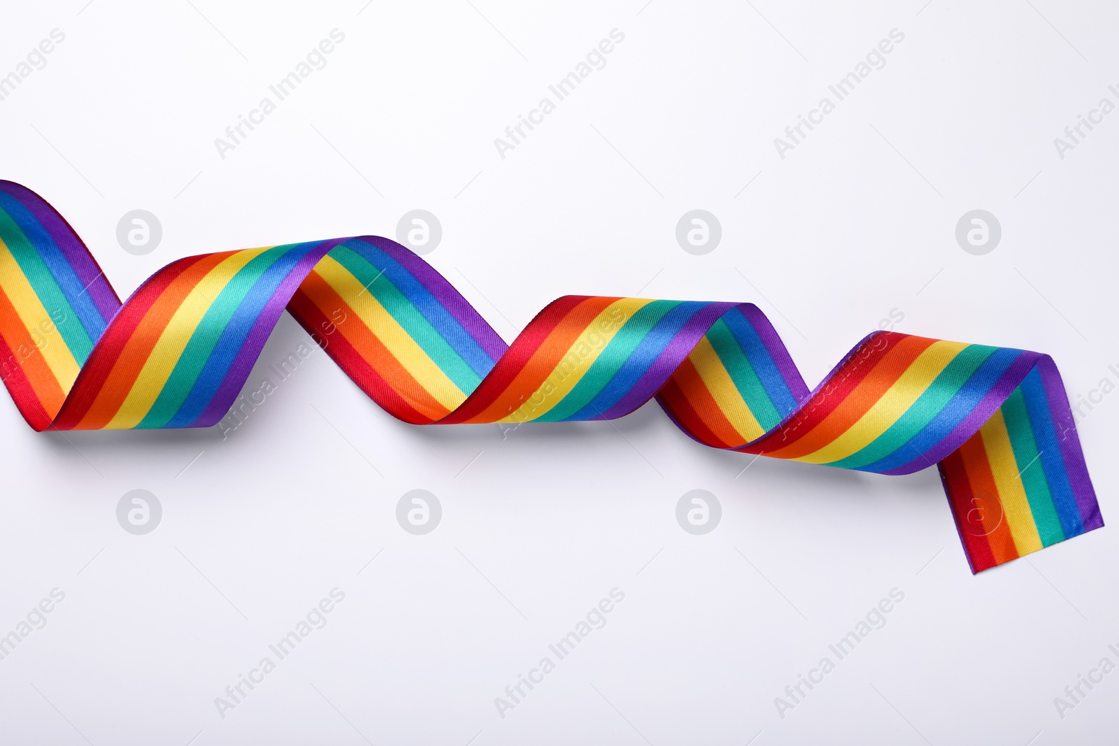 Photo of Rainbow ribbon on white background, top view. LGBT pride