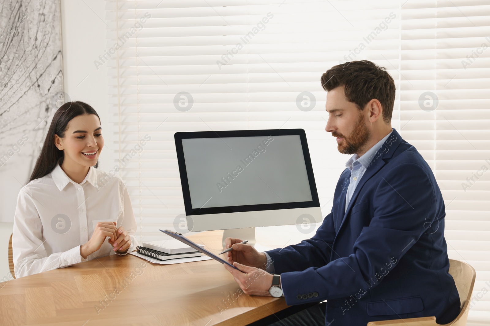 Photo of Human resources manager reading applicant's resume in office